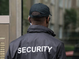 Rear View Of A Male Security Guard Wearing Black Uniform