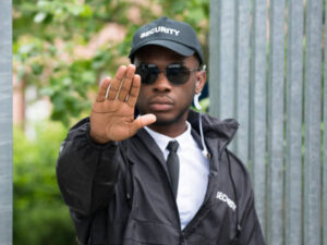 Confident Young African Male Security Guard Making Stop Gesture