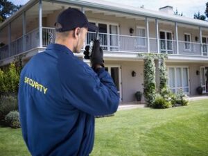 security-guard-using-radio-outside-house_1134-20072